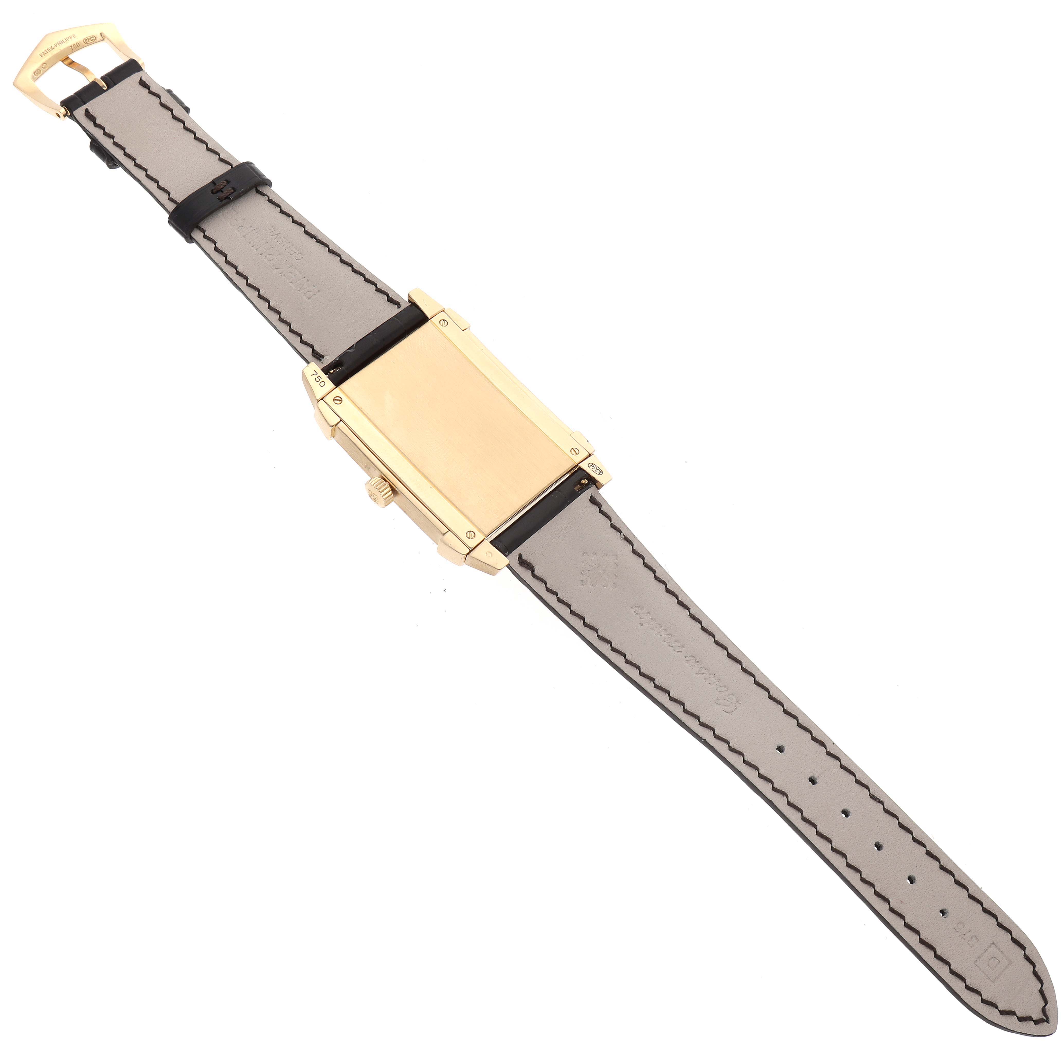 The image shows the underside of a Patek Philippe Gondolo 5111J Men's Yellow Gold Silver Dial 5111J Men's Yellow Gold Silver Dial model watch, highlighting the back case and strap.