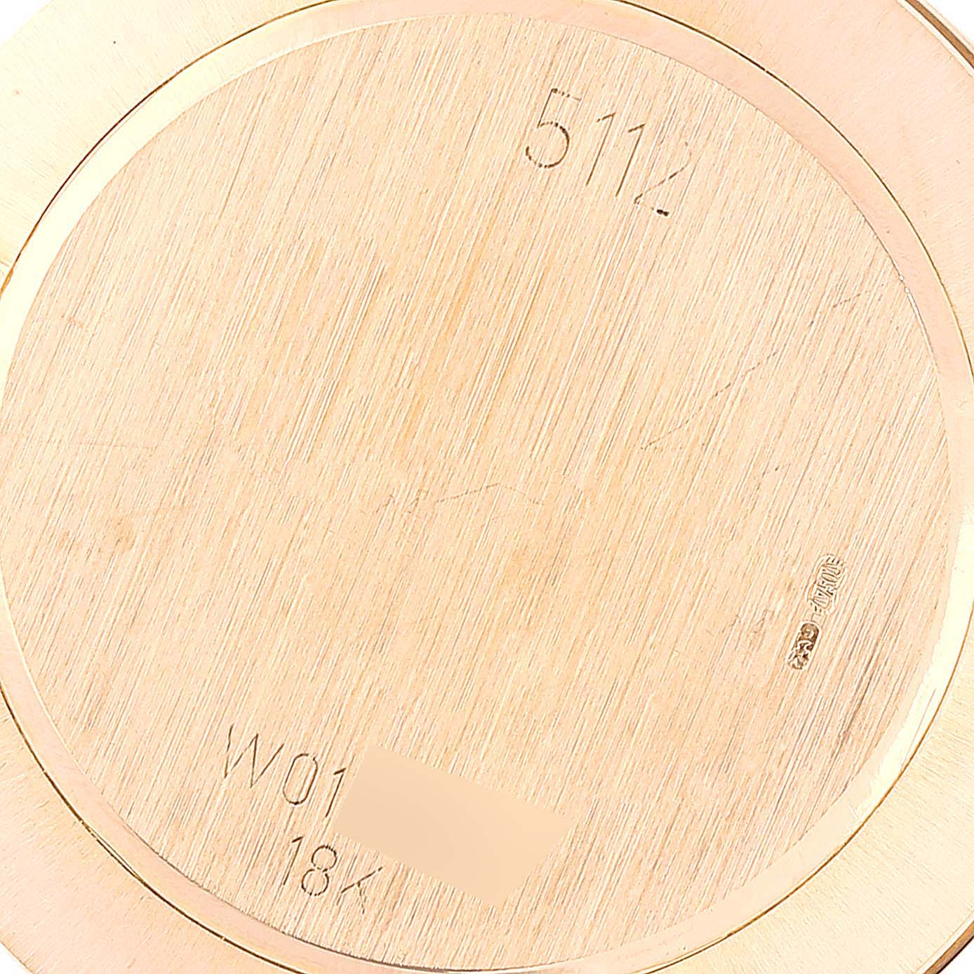 This image shows the back casing of a Rolex Cellini 5112 Men's Yellow Gold Beige Dial 5112 Men's Yellow Gold Beige Dial watch, featuring engraving details and material specifications.