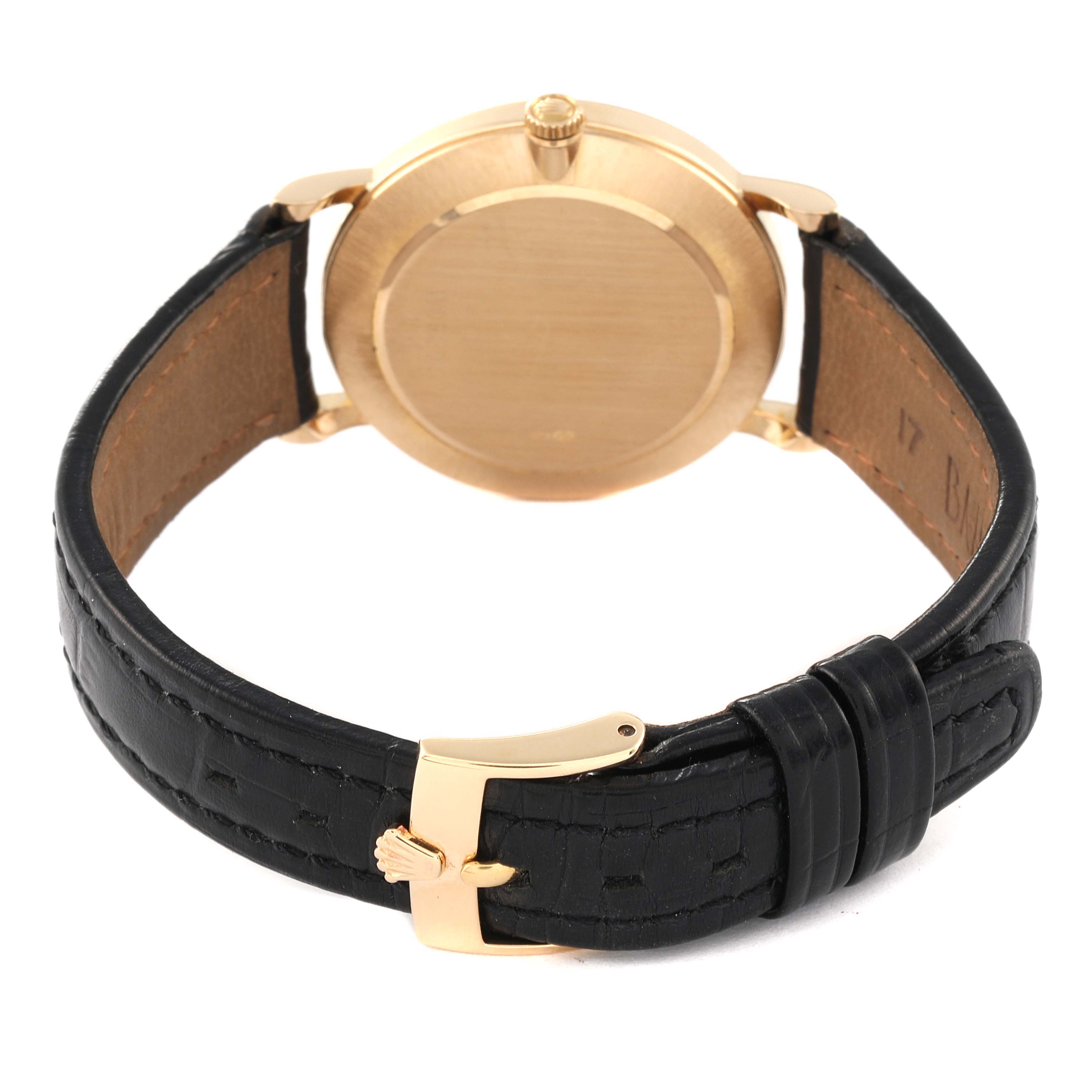 The image shows the back view of a Rolex Cellini 5112 Men's Yellow Gold Beige Dial 5112 Men's Yellow Gold Beige Dial watch, highlighting the case back and black leather strap with a gold buckle.