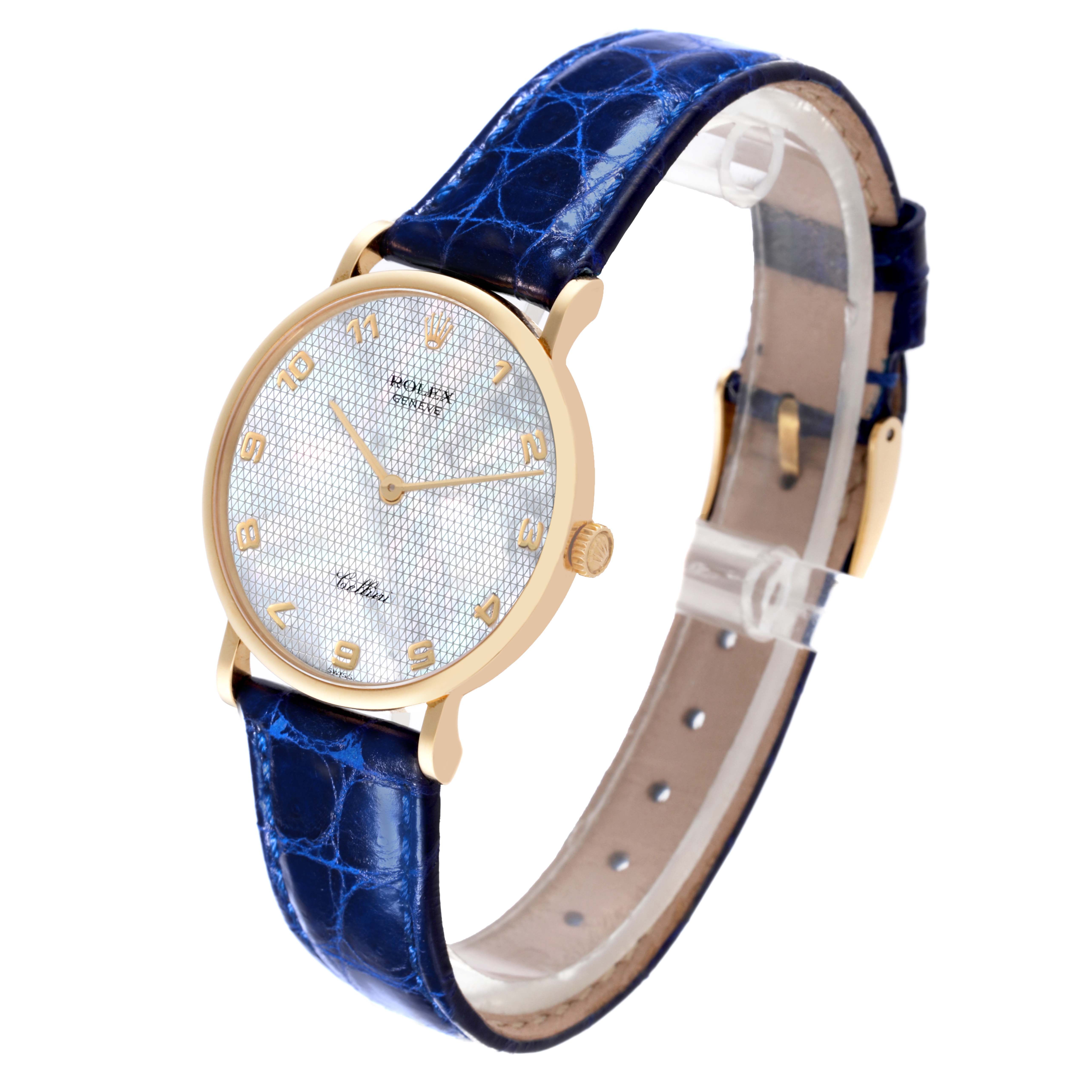 The image shows a Rolex Cellini 5112 Men's Yellow Gold Mother of Pearl Dial 5112 Men's Yellow Gold Mother of Pearl Dial watch at an angle, highlighting its gold case, blue leather strap, and textured dial.