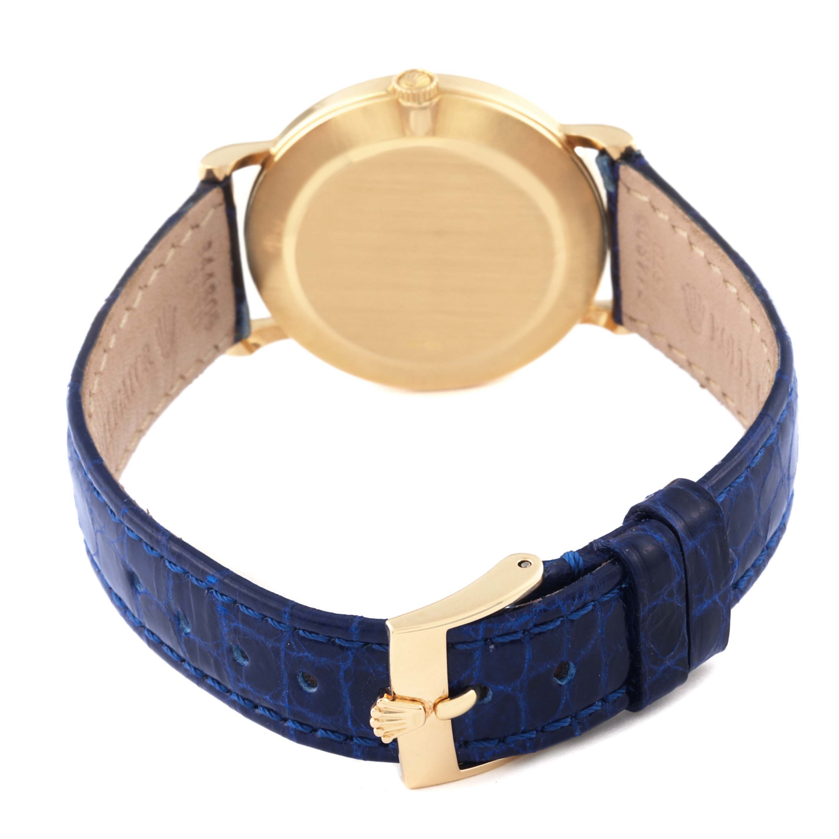 The image shows the back view of a Rolex Cellini 5112 Men's Yellow Gold Mother of Pearl Dial 5112 Men's Yellow Gold Mother of Pearl Dial watch with a blue leather strap and gold clasp.