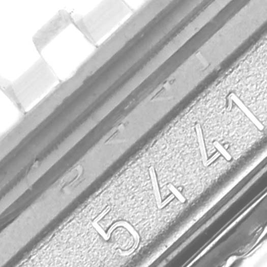 This close-up angle of the Rolex Cellini 5441 Men's White Gold Silver Dial 5441 Men's White Gold Silver Dial model displays part of the watch bezel and case with the engraved serial number.