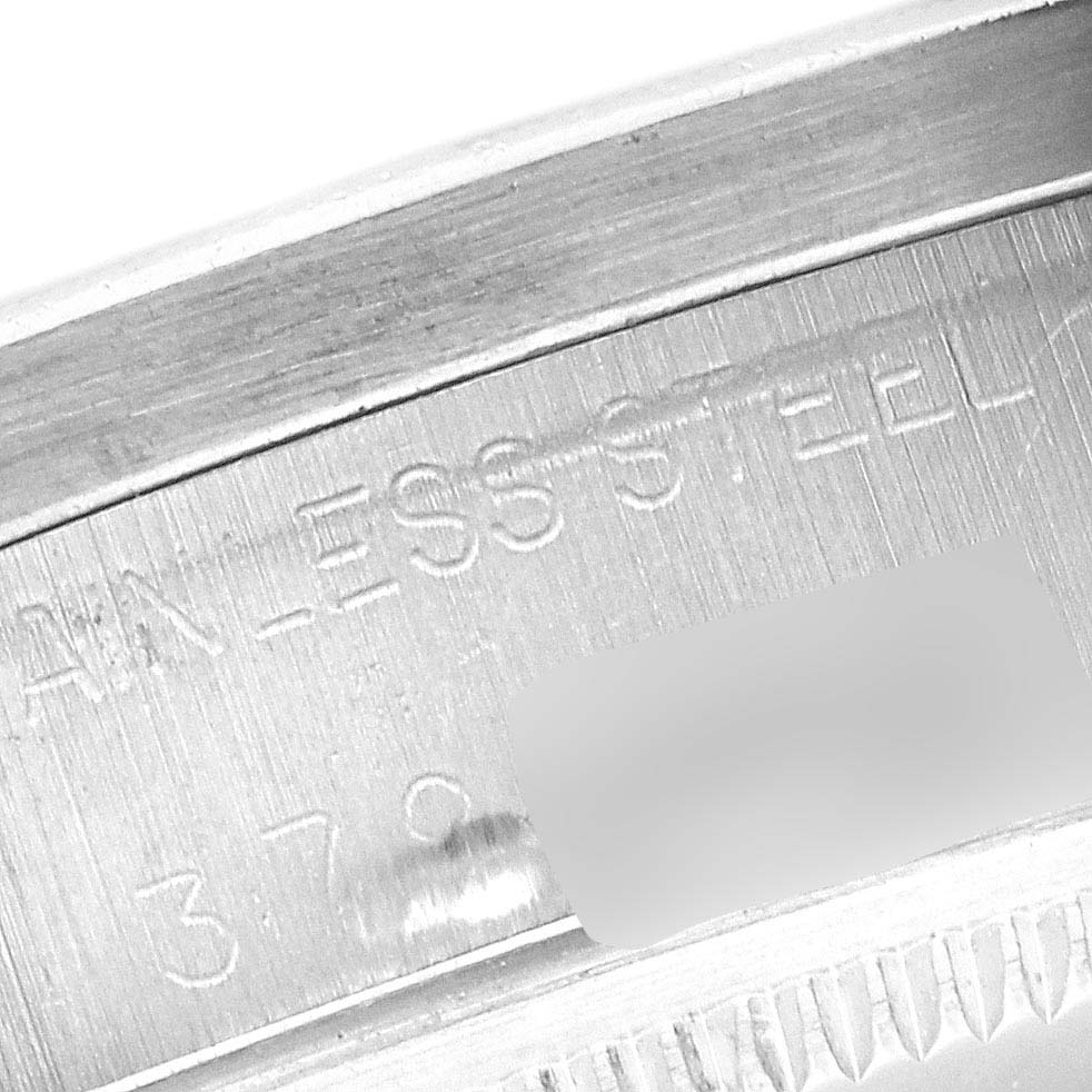 This image shows a close-up of the side engraving on a Rolex Date 1501 Men's Stainless Steel Champagne Dial 1501 Men's Stainless Steel Champagne Dial model watch, highlighting text that includes "STAINLESS STEEL".