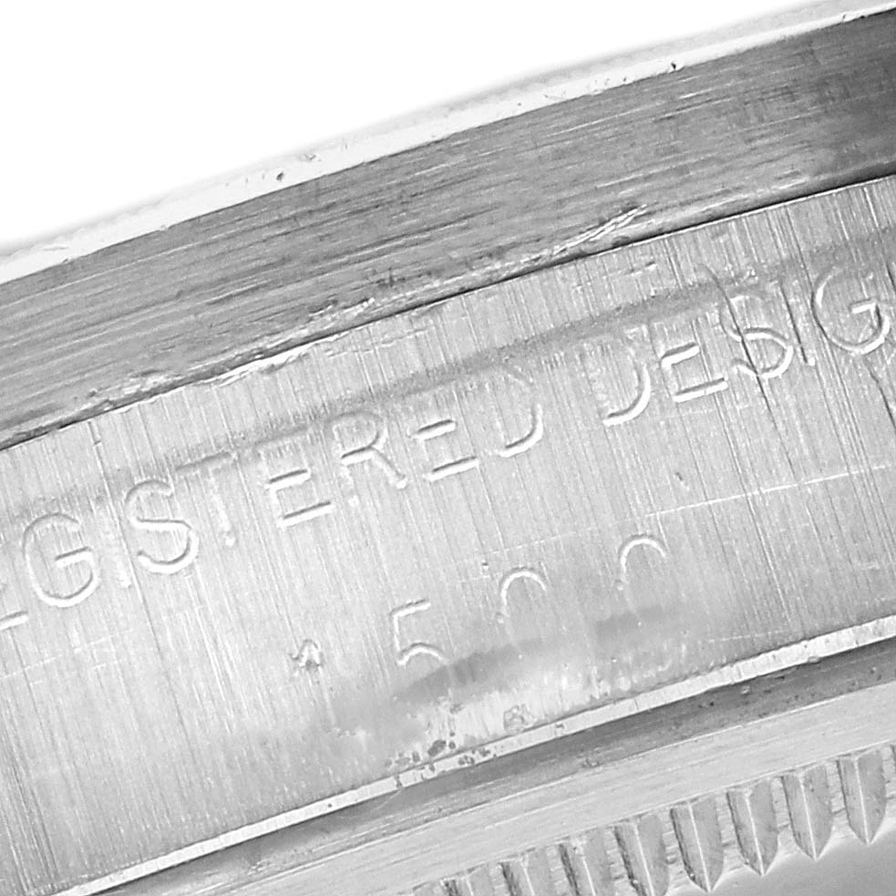 This image shows a close-up of the inner casing with engraved text on the Rolex Date 1501 Men's Stainless Steel Champagne Dial 1501 Men's Stainless Steel Champagne Dial model watch.