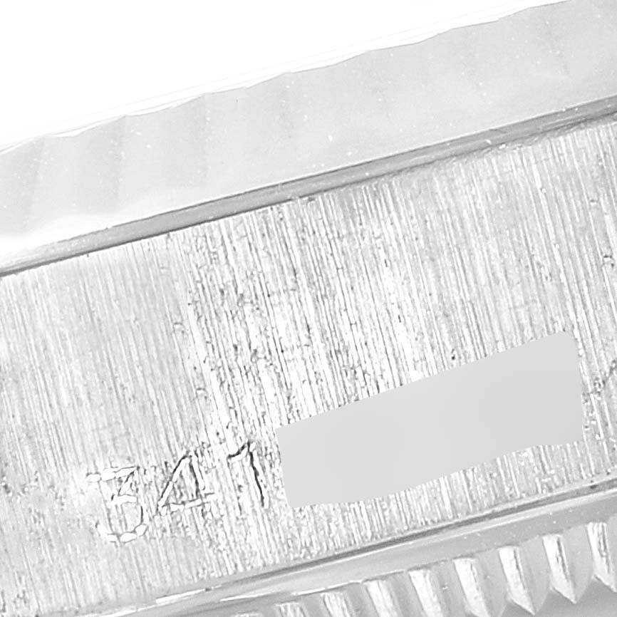 This close-up image shows the engraved serial number on the side of the bezel of a Rolex Date 6917 Women's Stainless Steel Silver Dial 6917 Women's Stainless Steel Silver Dial model watch.