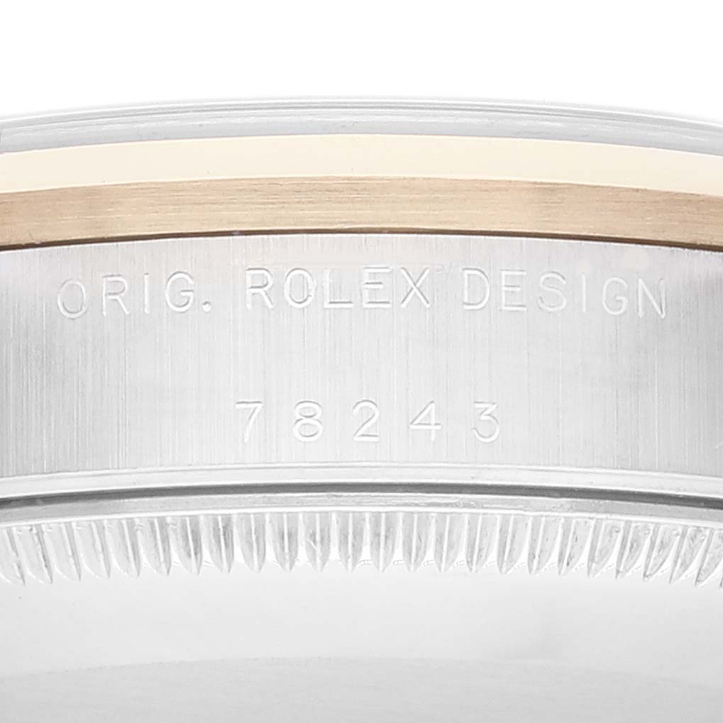 This image shows a close-up of the side of a Rolex Mid-Size 78243 Women's Steel and Gold (two tone) Grey Dial 78243 Women's Steel and Gold (two tone) Grey Dial watch case, highlighting the engraved model number and design text.