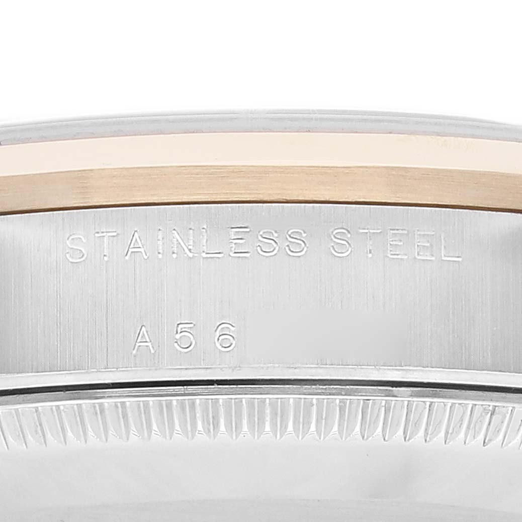This is a close-up view of the stainless steel case back and part of the bezel of a Rolex Mid-Size 78243 Women's Steel and Gold (two tone) Grey Dial 78243 Women's Steel and Gold (two tone) Grey Dial model.