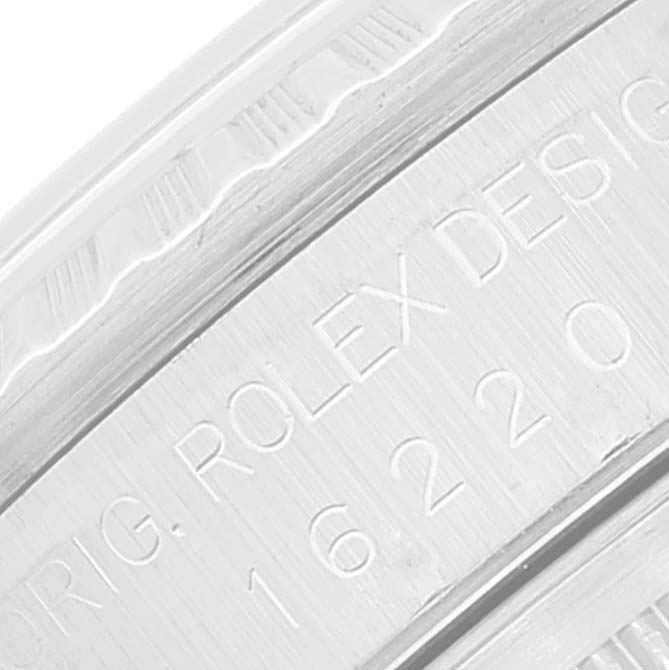 This image shows a close-up of the engraved text on the case of a Rolex Datejust 16220 Men's Stainless Steel Blue Dial 16220 Men's Stainless Steel Blue Dial watch, specifically the model number.
