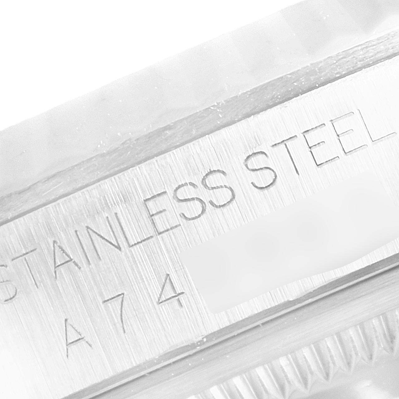 The image shows a close-up of the side engraving and fluted bezel of a Rolex Datejust 16234 Men
s Stainless Steel Blue Dial 16234 Men
s Stainless Steel Blue Dial watch in stainless steel.