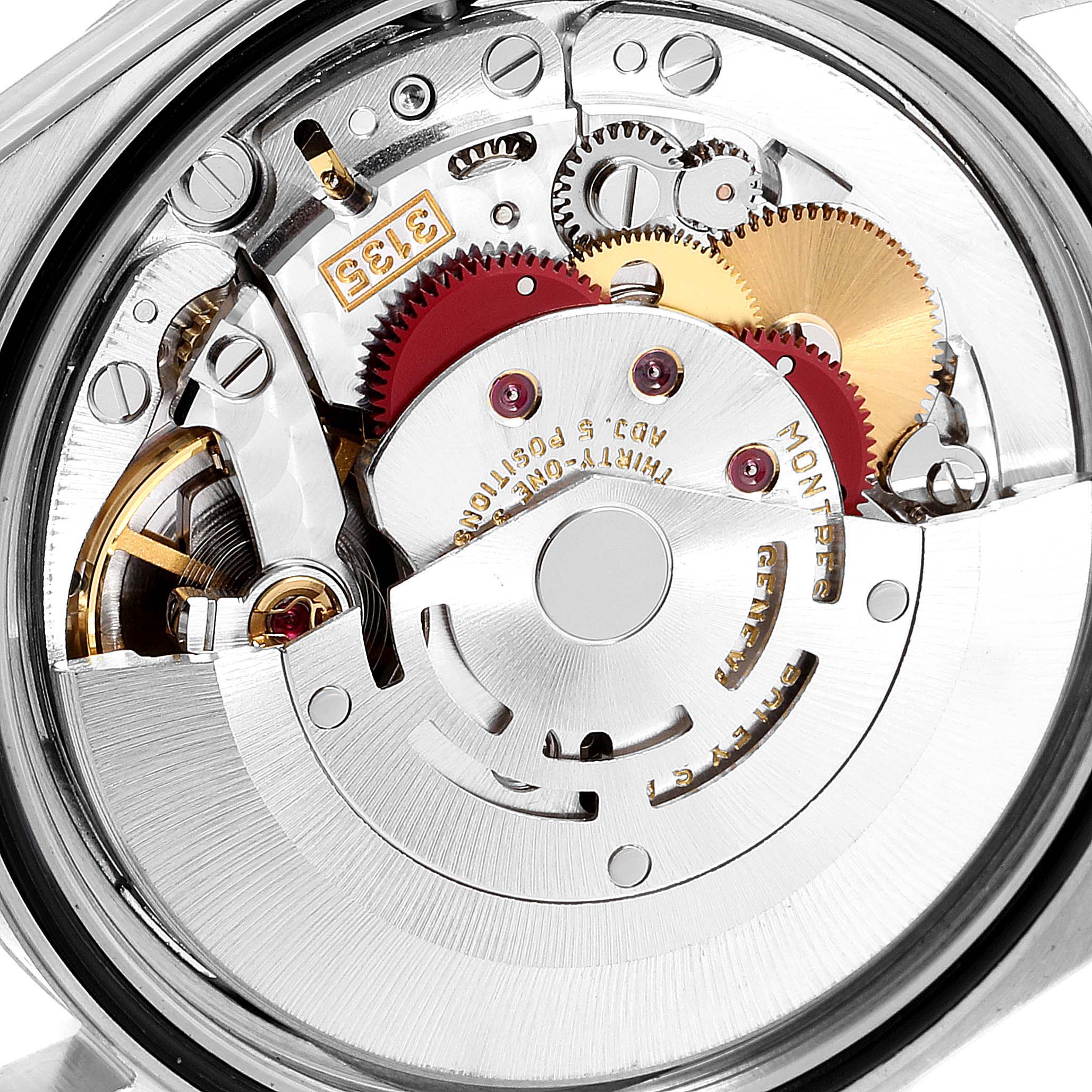 The image shows the intricate internal mechanism of a Rolex Datejust 16234 Men
s Stainless Steel Blue Dial 16234 Men
s Stainless Steel Blue Dial watch, focusing on the gears and rotor.