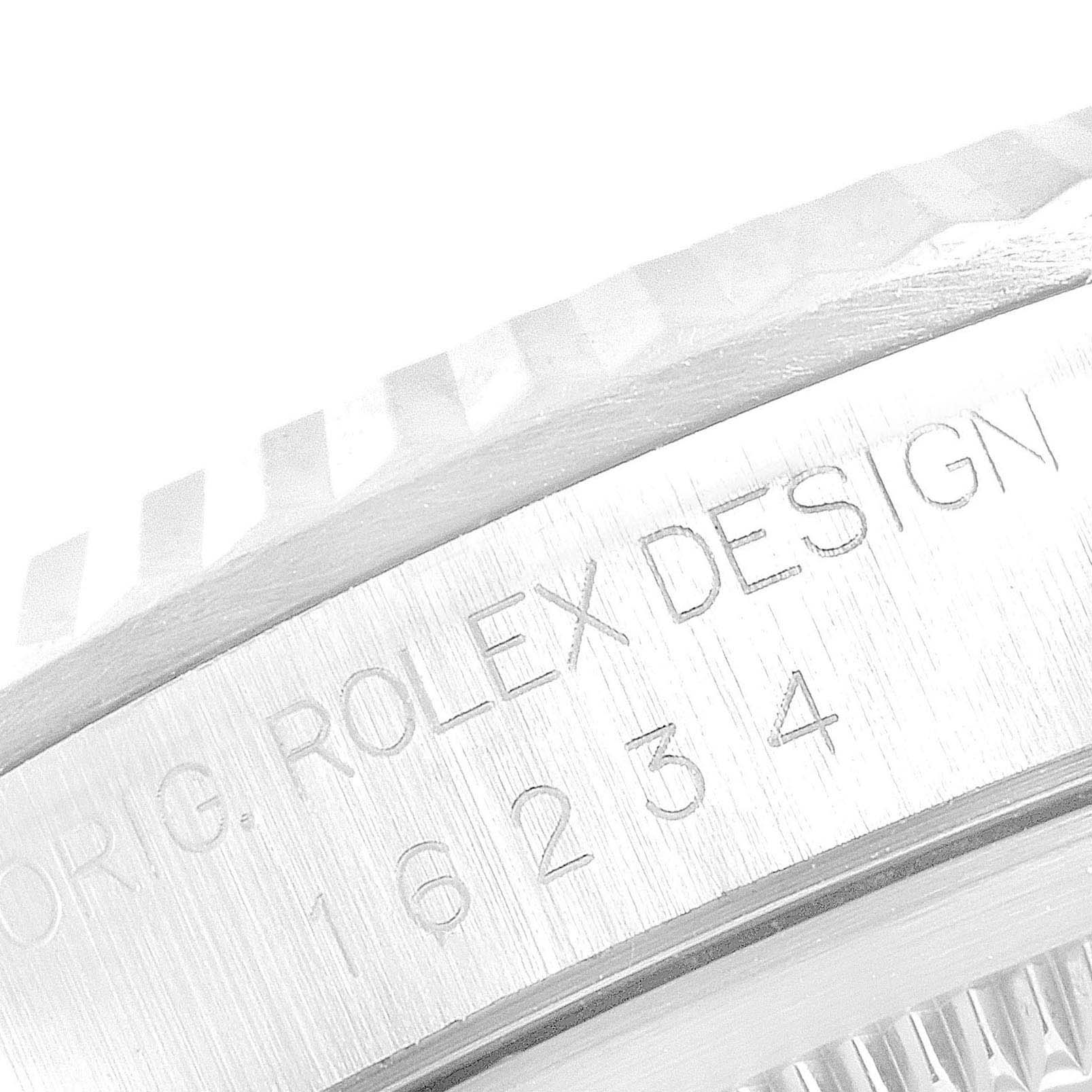 This close-up image shows the engraved bezel and serial number of a Rolex Datejust 16234 Men
s Stainless Steel Blue Dial 16234 Men
s Stainless Steel Blue Dial watch.