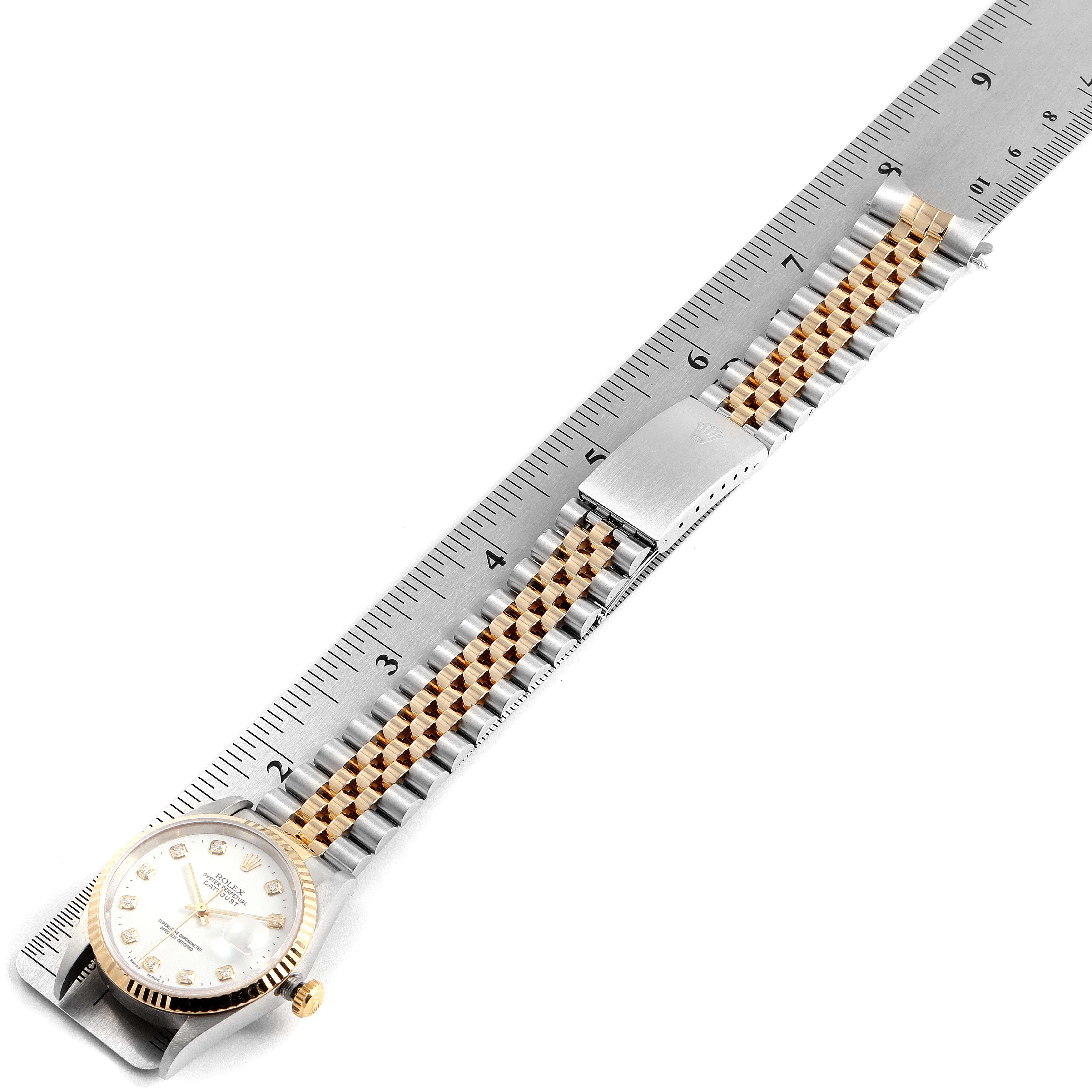 The image shows a Rolex Datejust 16233 Men's Steel and Gold (two tone) White Dial 16233 Men's Steel and Gold (two tone) White Dial watch laid flat with its bracelet aligned to a ruler for measurement.