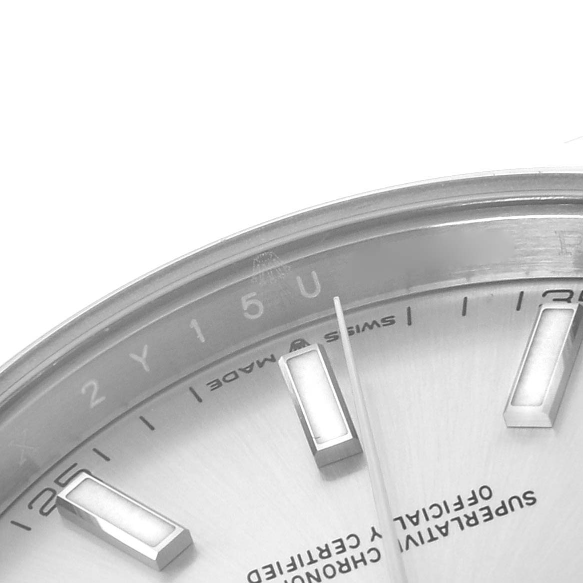 The image shows a close-up of a portion of the dial on a Rolex Datejust 41 126300 Men
s Stainless Steel Silver Dial 126300 Men
s Stainless Steel Silver Dial watch, focusing on the hour markers and text.