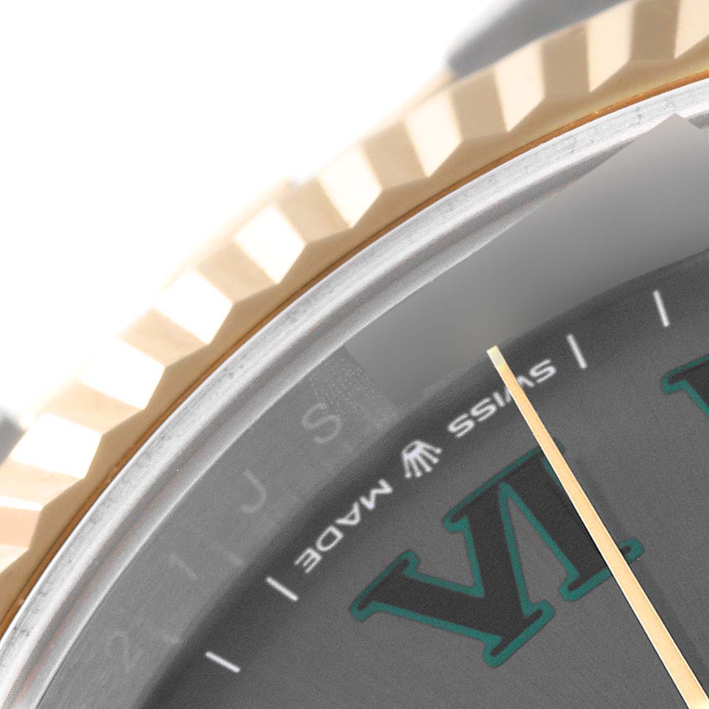 This close-up image of the Rolex Datejust 41 126333 Men's Steel and Gold (two tone) Grey Dial 126333 Men's Steel and Gold (two tone) Grey Dial shows part of the dial, a fluted bezel, and the "Swiss Made" text with the Rolex crown logo.