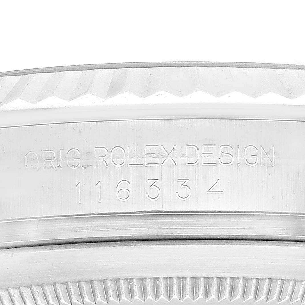 This image shows a close-up of the fluted bezel with engraving of a Rolex Datejust 41 116334 Men
s Stainless Steel Blue Dial 116334 Men
s Stainless Steel Blue Dial model watch, displaying "ORIG-ROLEX DESIGN" and model number "116334".