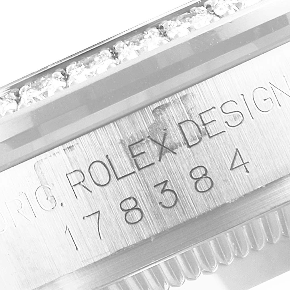 This image shows a close-up angle of the bezel and engraved serial number of a Rolex Mid-Size 178384 Women's Stainless Steel Blue Dial 178384 Women's Stainless Steel Blue Dial model watch.