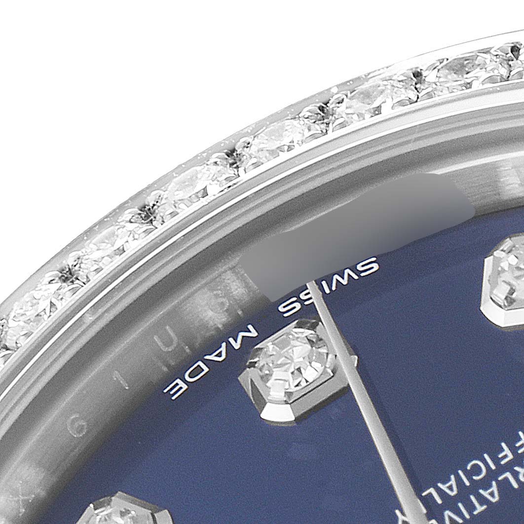 This close-up angle shows the diamond-set bezel and part of the dial and hands of a Rolex Mid-Size 178384 Women's Stainless Steel Blue Dial 178384 Women's Stainless Steel Blue Dial model watch.