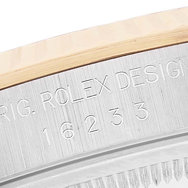 Close-up angle showing a portion of the bezel and engraved side of a Rolex Datejust 16233 Men's Steel and Gold (two tone) White Dial 16233 Men's Steel and Gold (two tone) White Dial model watch.