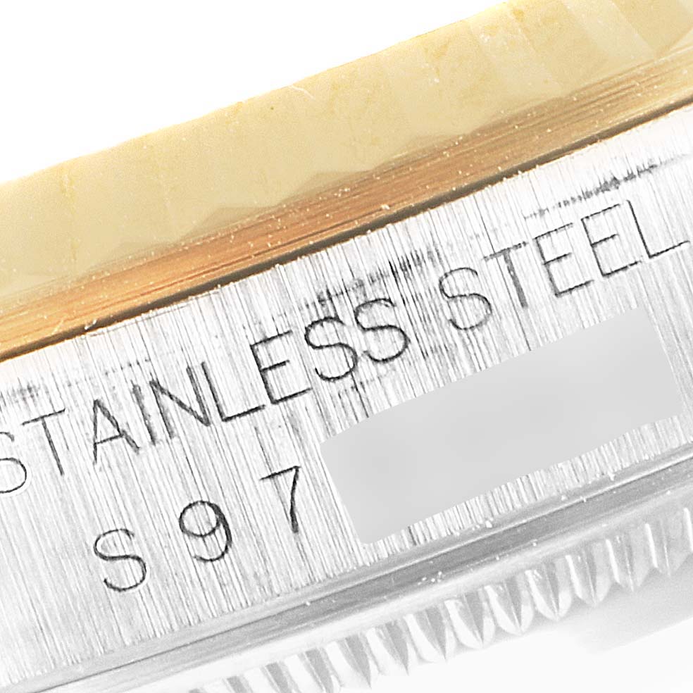 This close-up image shows a side view of the Rolex Datejust 16233 Men's Steel and Gold (two tone) Champagne Dial 16233 Men's Steel and Gold (two tone) Champagne Dial watch case with "STAINLESS STEEL" engraved.