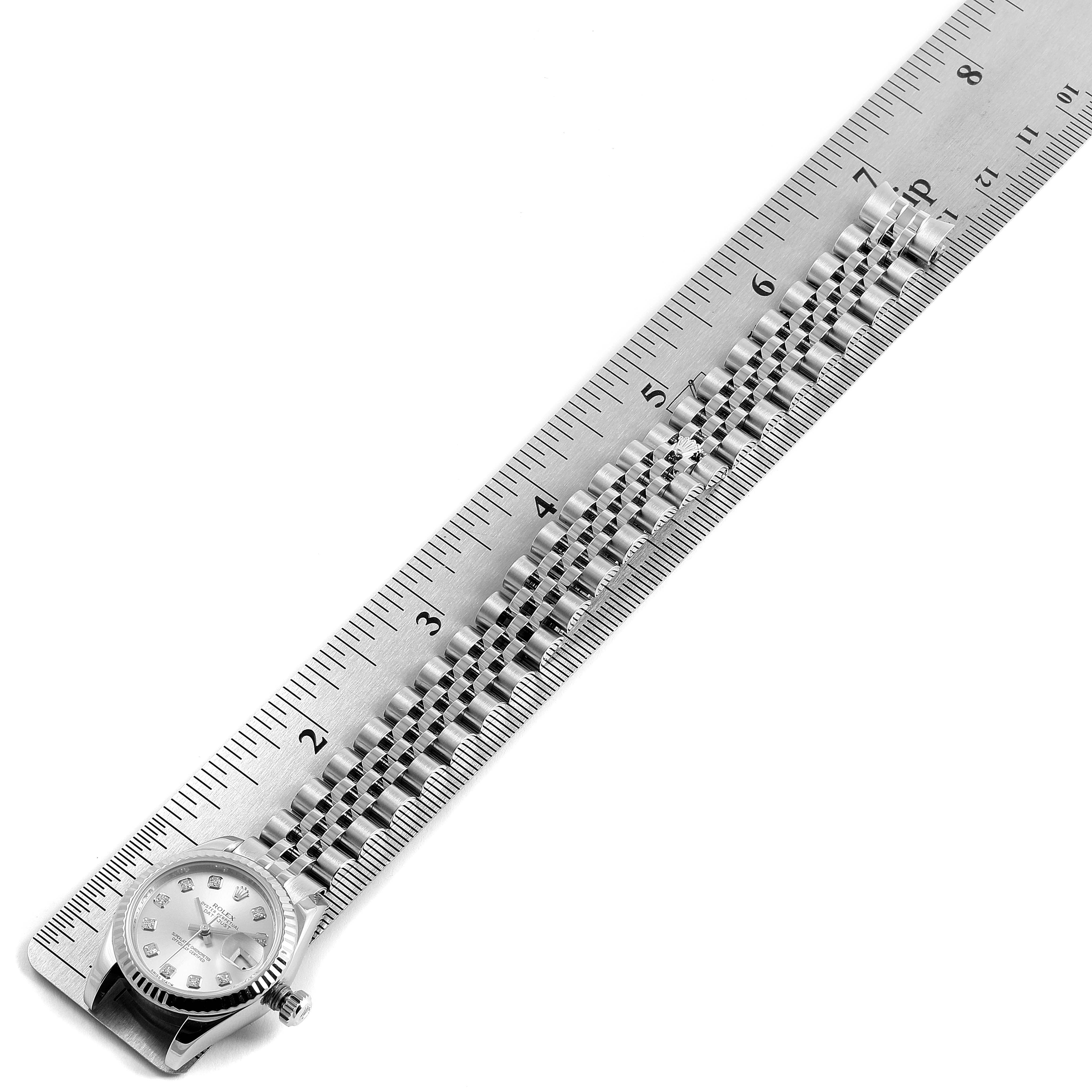 The image shows a Rolex Datejust 179174 Women's Stainless Steel Silver Dial 179174 Women's Stainless Steel Silver Dial watch laid flat next to a ruler, displaying the face and bracelet.