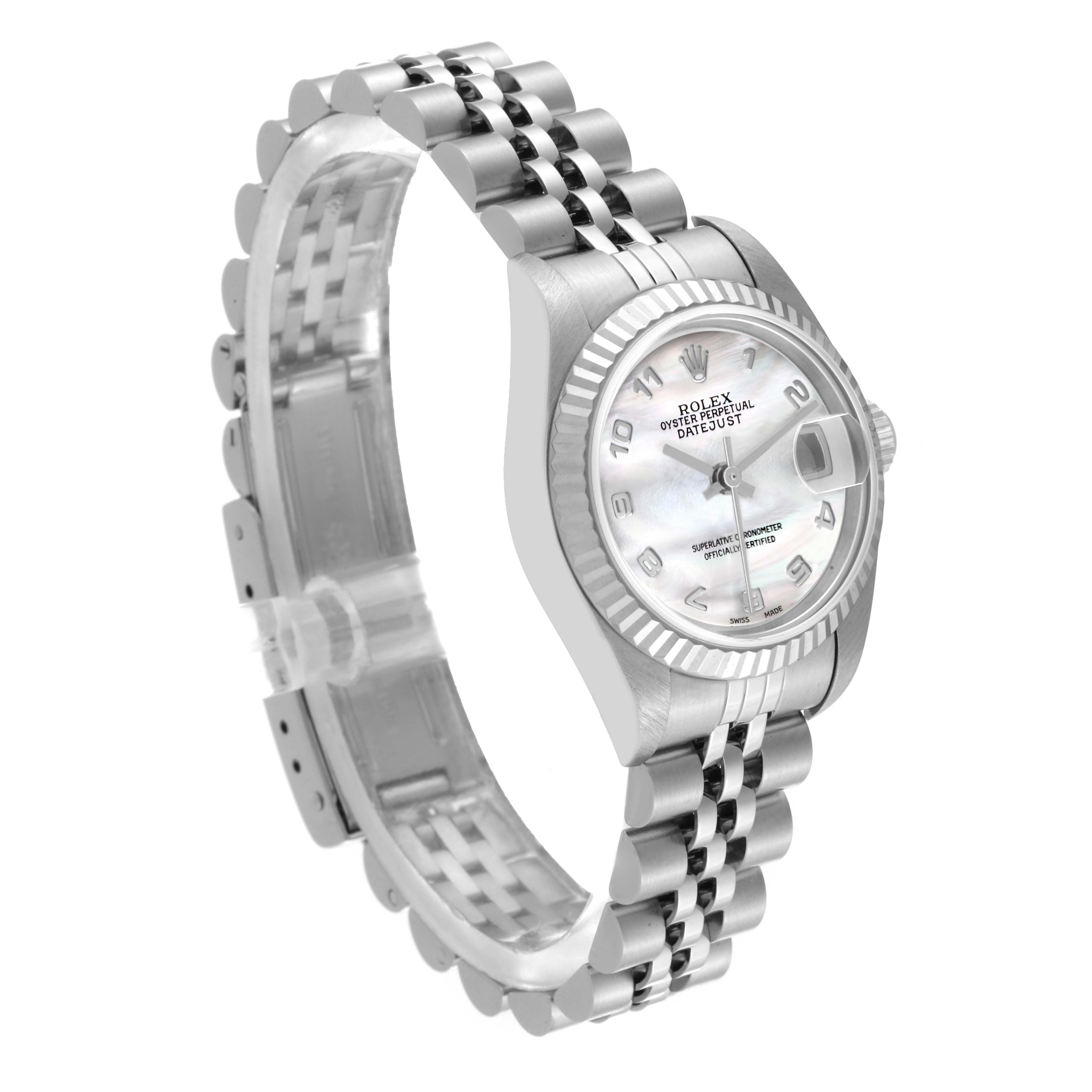 The Rolex Datejust 79174 Women
s Stainless Steel Mother of Pearl Dial 79174 Women
s Stainless Steel Mother of Pearl Dial watch is shown at a three-quarter angle, displaying its face, crown, and Jubilee bracelet.