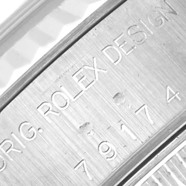 Close-up of the engraved text and serial number on the inner bezel of a Rolex Datejust 79174 Women
s Stainless Steel Mother of Pearl Dial 79174 Women
s Stainless Steel Mother of Pearl Dial watch.
