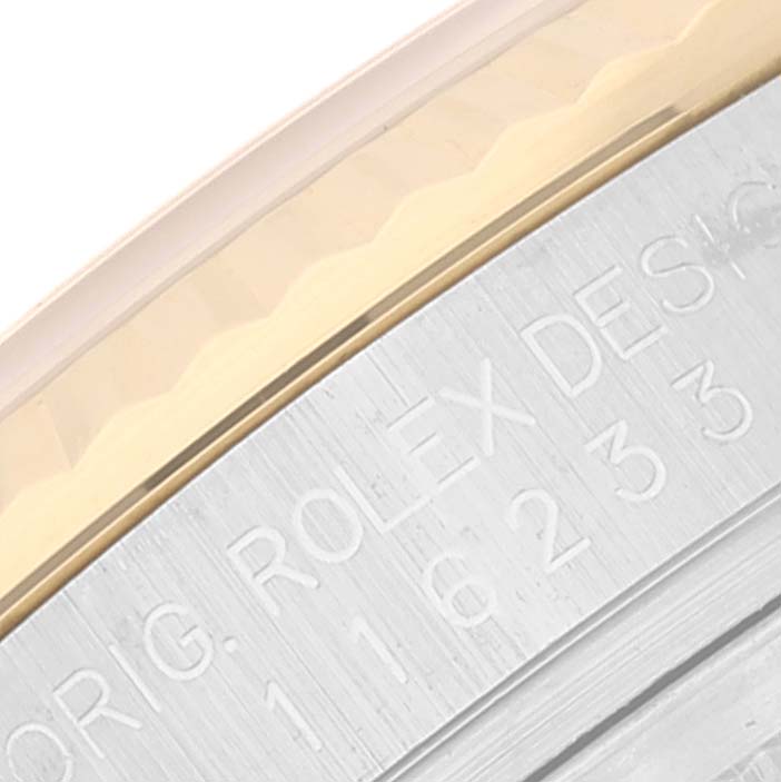 This image shows a close-up of the engraved case side and bezel of a Rolex Datejust 116233 Men's Steel and Gold (two tone) Black Dial 116233 Men's Steel and Gold (two tone) Black Dial watch.