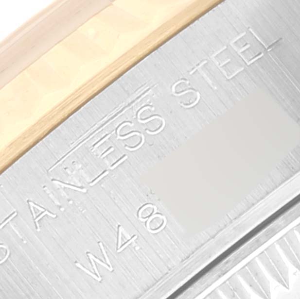 This close-up angle of the Rolex Datejust 69173 Women's Steel and Gold (two tone) Champagne Dial 69173 Women's Steel and Gold (two tone) Champagne Dial shows part of the watch casing inscribed with "STAINLESS STEEL" and "W48."