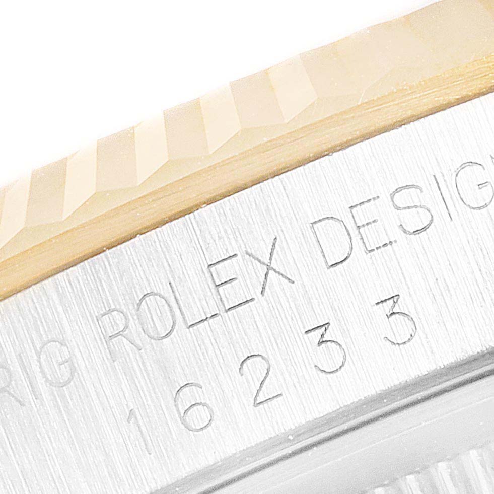 The image shows a close-up of the engraved case side of a Rolex Datejust 16233 Men's Steel and Gold (two tone) Blue Dial 16233 Men's Steel and Gold (two tone) Blue Dial watch, displaying the model number and text.