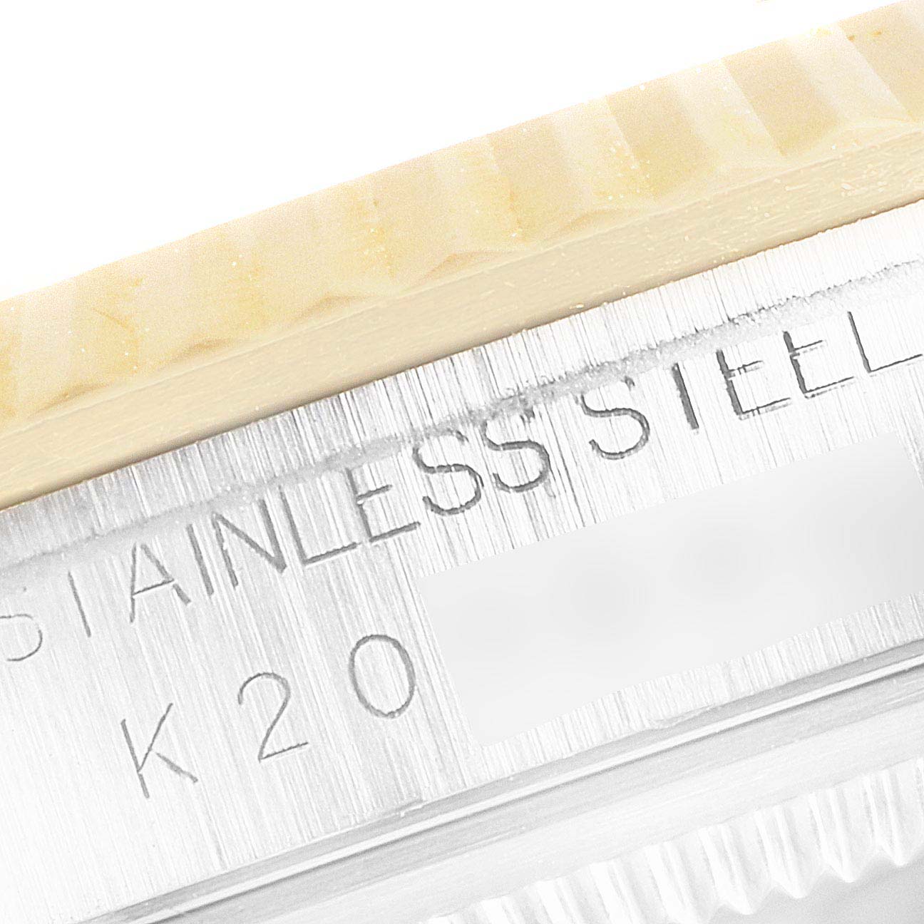 This image shows a close-up side view of the bezel and case of a Rolex Datejust 16233 Men's Steel and Gold (two tone) Blue Dial 16233 Men's Steel and Gold (two tone) Blue Dial model, highlighting the "STAINLESS STEEL" engraving.