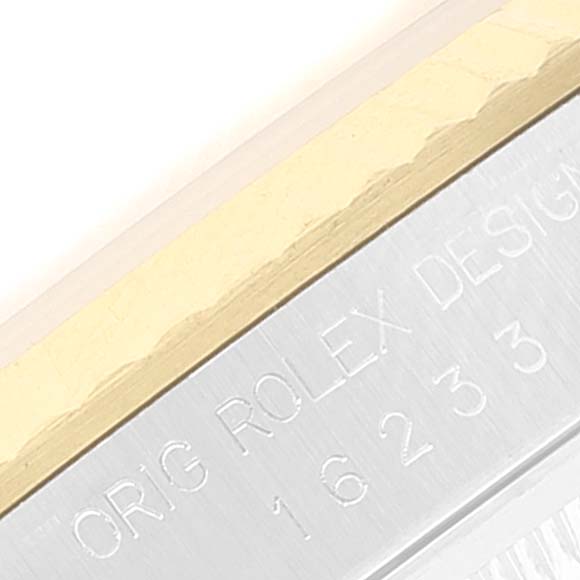 This close-up image of a Rolex Datejust 16233 Men's Steel and Gold (two tone) White Dial 16233 Men's Steel and Gold (two tone) White Dial watch shows the engraved model number and part of the bezel.