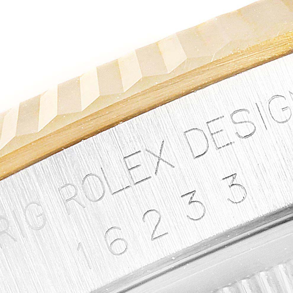 The image shows a close-up of the bezel and serial engraving on a Rolex Datejust 16233 Men's Steel and Gold (two tone) White Dial 16233 Men's Steel and Gold (two tone) White Dial watch.