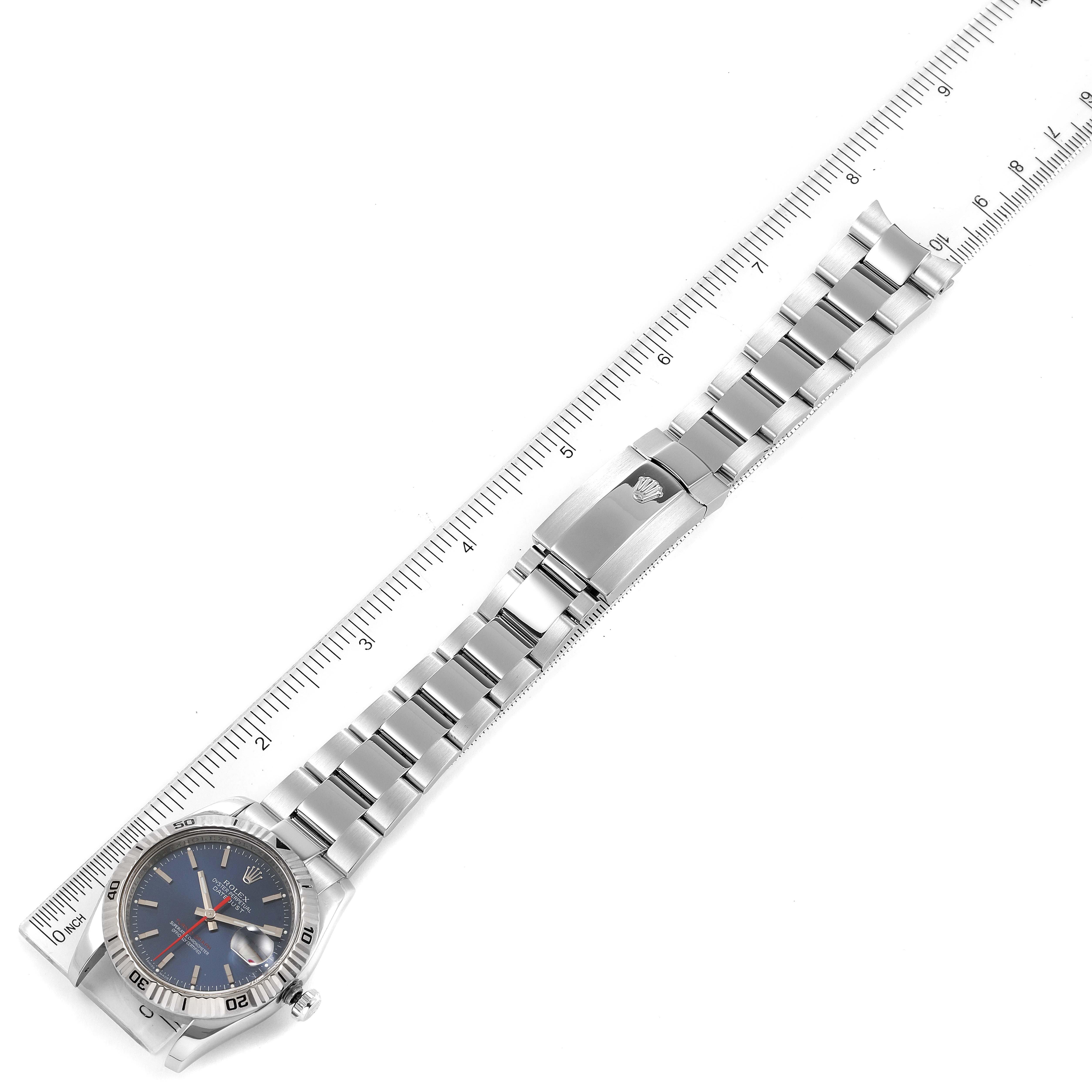 The image shows a full top view of a Rolex Turn-o-Graph 116264 Men
s Stainless Steel Blue Dial 116264 Men
s Stainless Steel Blue Dial watch, including its face, bracelet, and clasp with a ruler for scale.