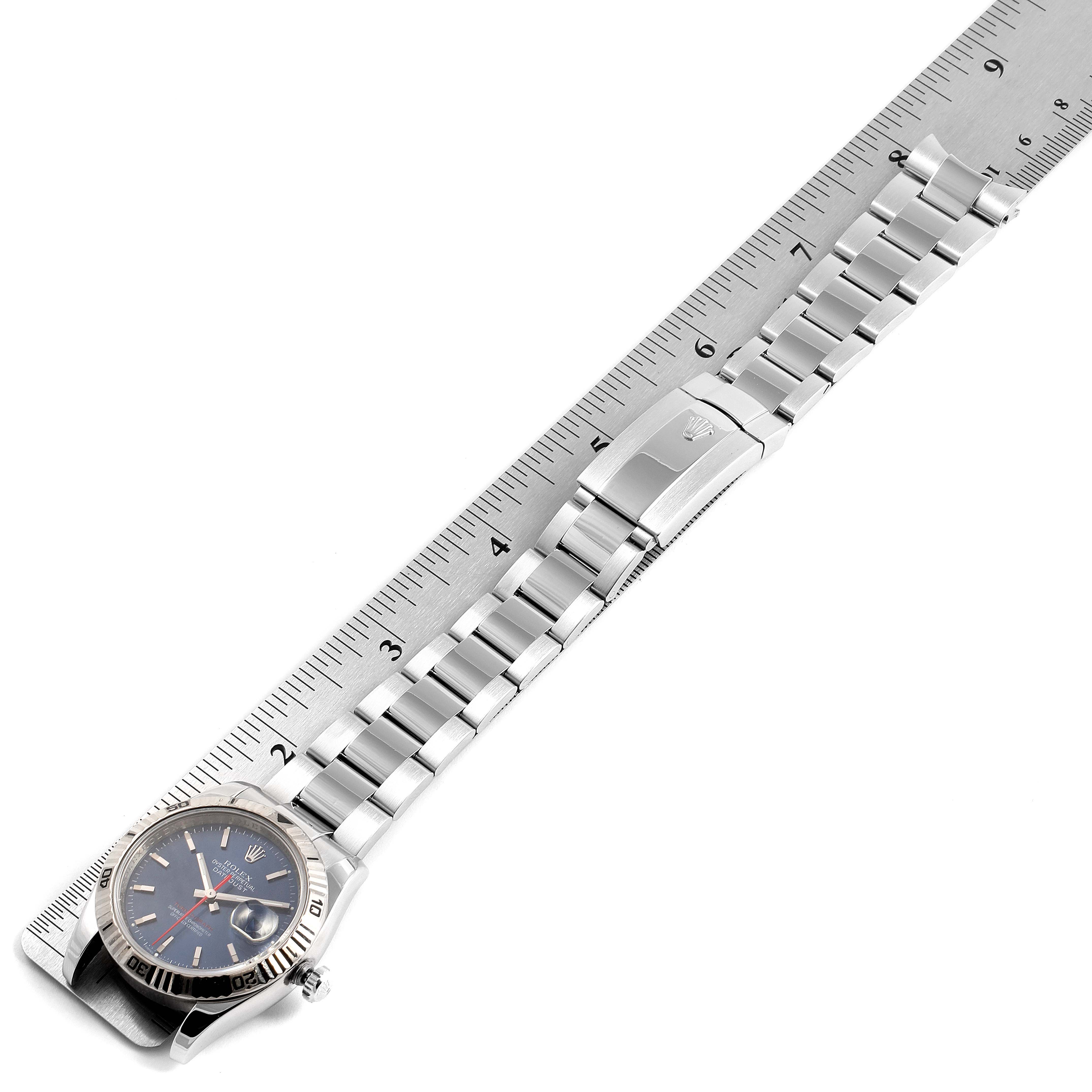The image shows a Rolex Turn-o-Graph 116264 Men's Stainless Steel Blue Dial 116264 Men's Stainless Steel Blue Dial watch with a metal bracelet laid next to a ruler for scale.