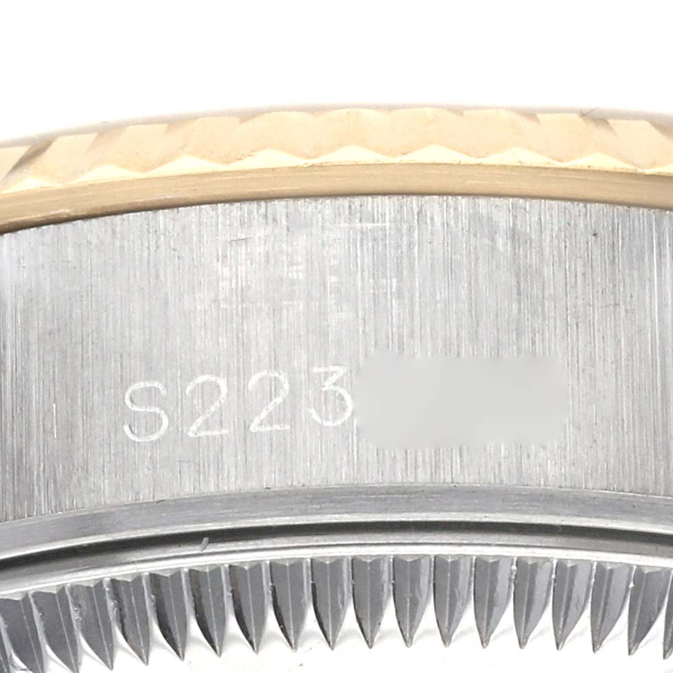This image shows a close-up of the side of the bezel and case with the serial number of the Rolex Datejust 69173 Women's Steel and Gold (two tone) Blue Dial 69173 Women's Steel and Gold (two tone) Blue Dial watch.