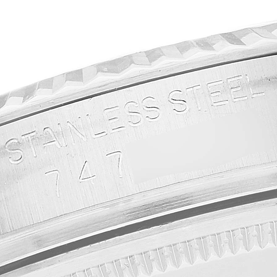The image shows a close-up of the stainless steel case engraved with "STAINLESS STEEL" and part of the serial number of a Rolex Vintage Collection 16014 Men's Stainless Steel Black Dial 16014 Men's Stainless Steel Black Dial watch.