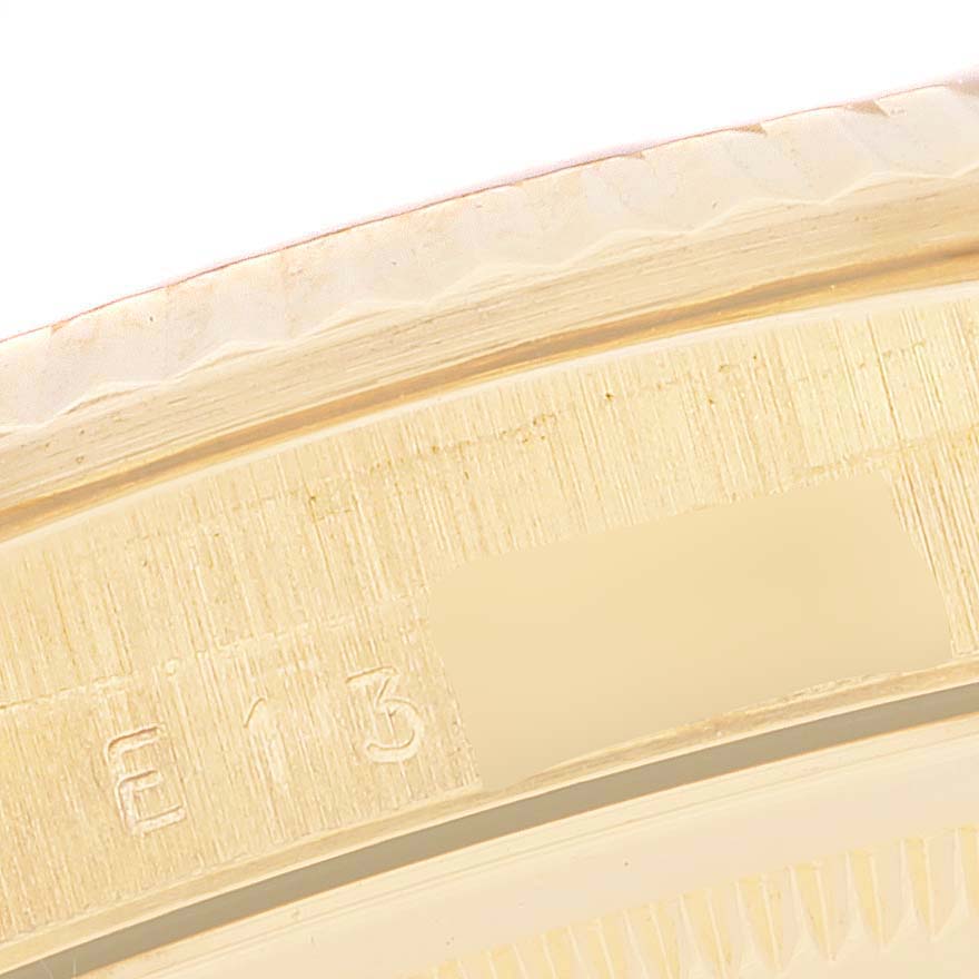 The image shows a close-up of the bezel with visible part numbers on a Rolex Datejust 16238 Men's Yellow Gold Champagne Dial 16238 Men's Yellow Gold Champagne Dial watch.