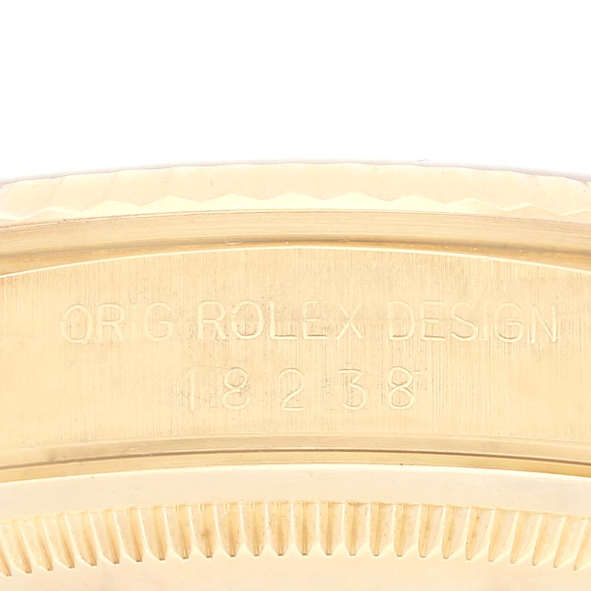 This image shows a close-up side view of the Rolex President 18238 Men
s Yellow Gold Champagne Dial 18238 Men
s Yellow Gold Champagne Dial model, highlighting the engraved design details on its case.