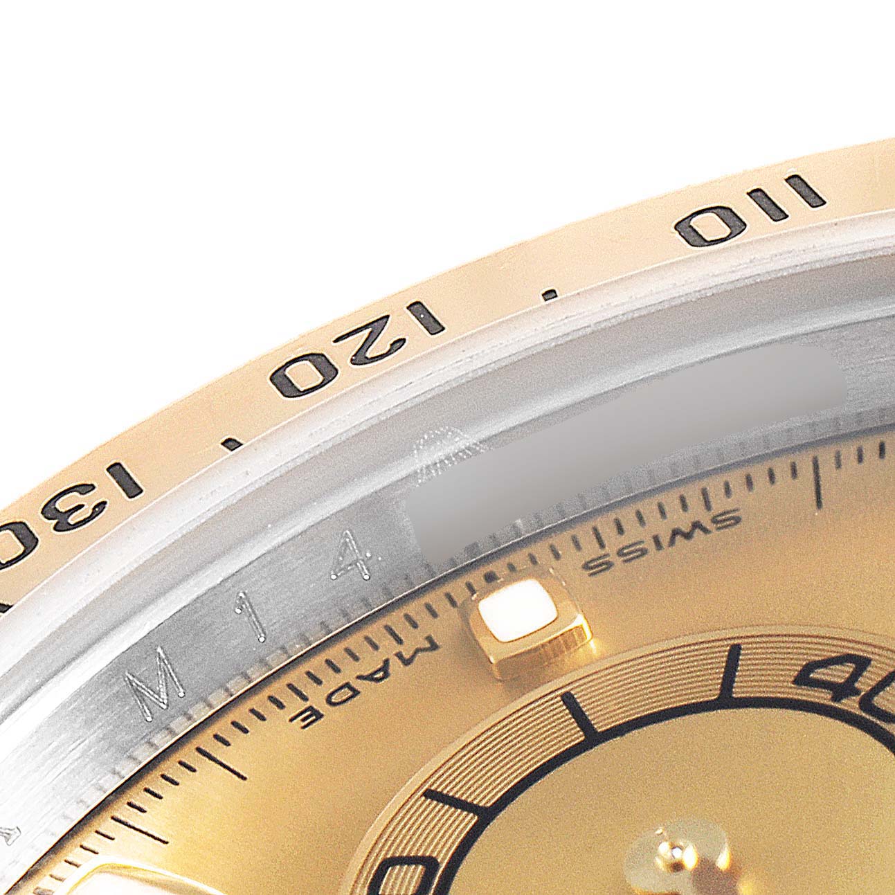 This image shows a close-up of the dial and outer bezel of a Rolex Daytona 116523 Men's Steel and Gold (two tone) Champagne Dial 116523 Men's Steel and Gold (two tone) Champagne Dial watch, highlighting the numerals and part of the face.