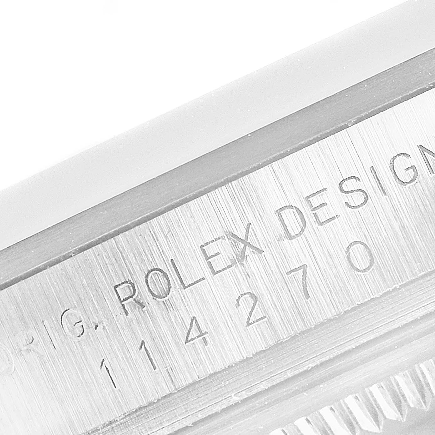 The image shows a close-up shot of the case side of a Rolex Explorer 14270 Men
s Stainless Steel Black Dial 14270 Men
s Stainless Steel Black Dial watch, highlighting its engraved serial number.