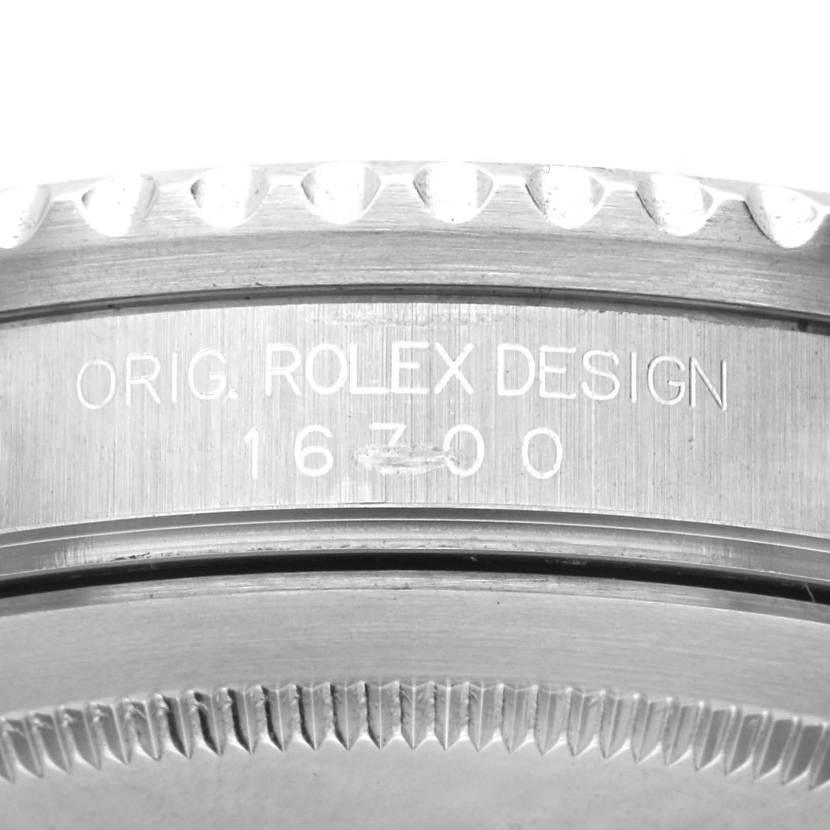 This image shows a close-up of the case side and bezel of the Rolex GMT-Master 16700 Men's Stainless Steel Black Dial 16700 Men's Stainless Steel Black Dial model with "ORIG. ROLEX DESIGN 16700" engraved.