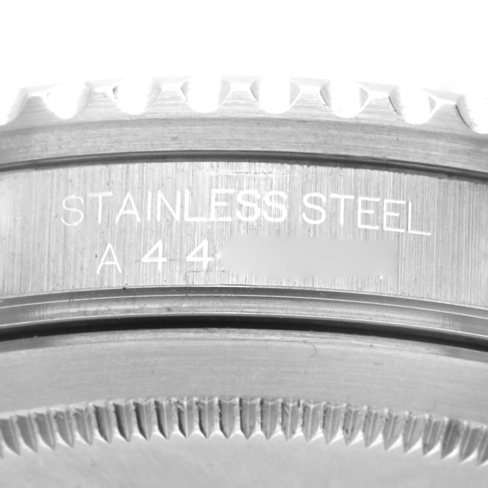 The image shows a close-up of the case back and bezel of a Rolex GMT-Master 16700 Men's Stainless Steel Black Dial 16700 Men's Stainless Steel Black Dial watch, highlighting its stainless steel build and serial number.