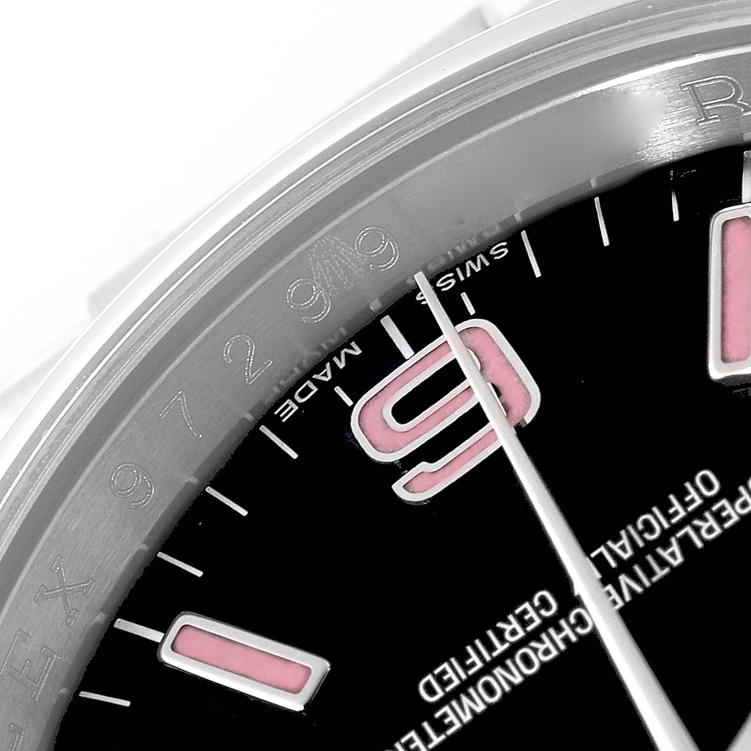 This close-up image of the Rolex Oyster Perpetual 116000 Men's Stainless Steel Black Dial 116000 Men's Stainless Steel Black Dial watch shows the dial with the number "9," minute markers, and part of the bezel.