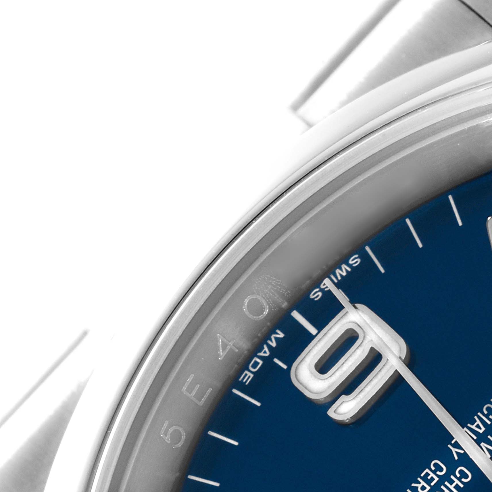 The image shows a close-up of the dial and bezel of the Rolex Oyster Perpetual 116000 Men's Stainless Steel Blue Dial 116000 Men's Stainless Steel Blue Dial watch, highlighting the "9" marker and the word "SWISS."