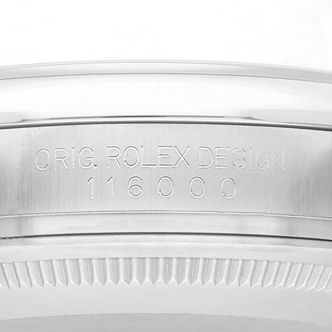This image shows the side view of the watch case of a Rolex Oyster Perpetual 116000 Men's Stainless Steel Blue Dial 116000 Men's Stainless Steel Blue Dial, displaying the model number "116000" and the engraving "Orig. Rolex Design."