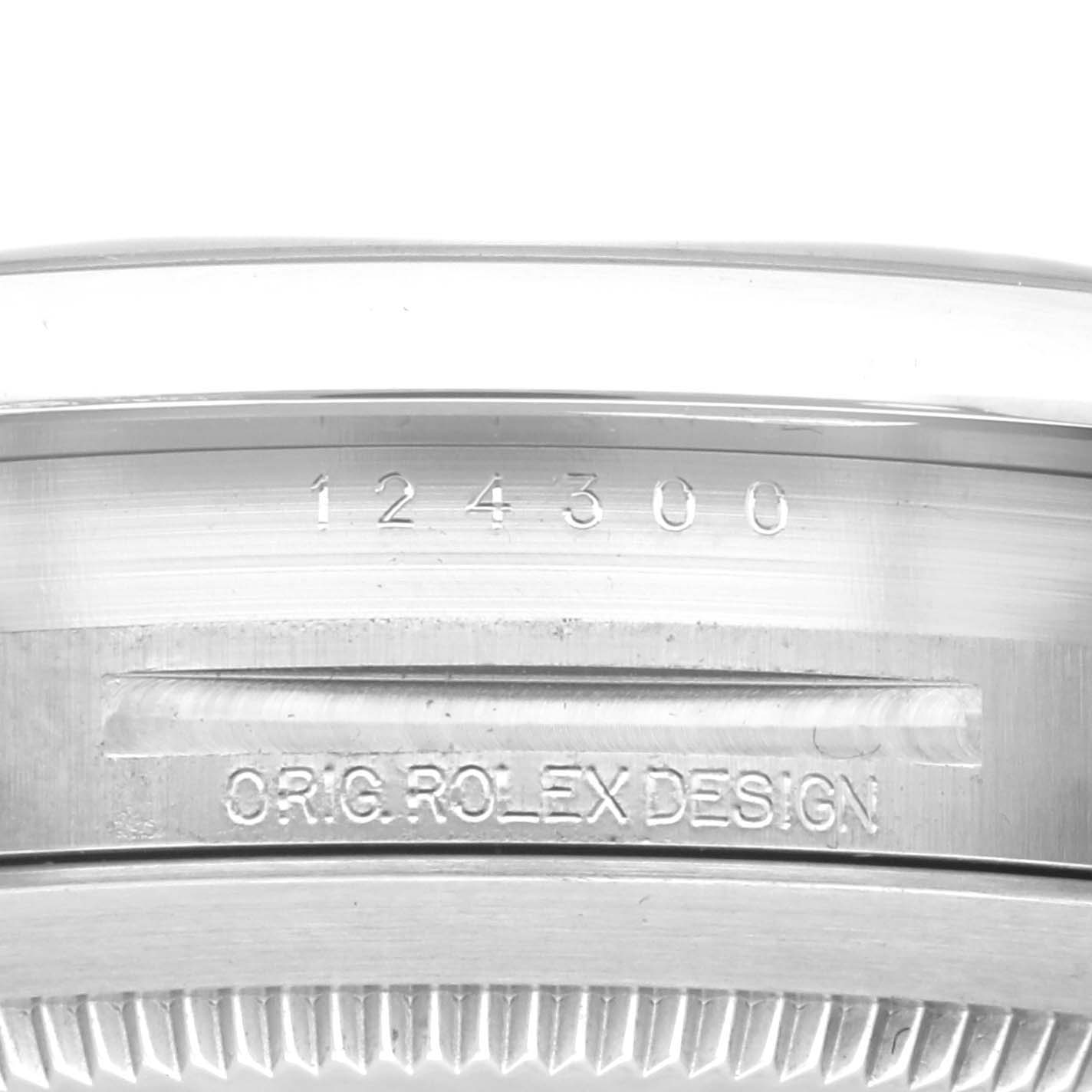 This image shows the side view of the case of a Rolex Oyster Perpetual 124300 Men's Stainless Steel Yellow Dial 124300 Men's Stainless Steel Yellow Dial watch, focusing on the model number and engraving.