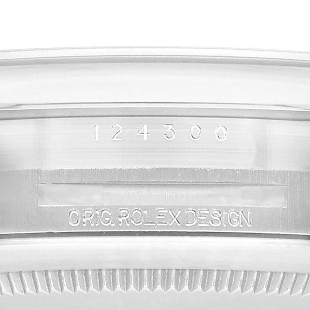 This image shows the engraving and serial number on the case edge of a Rolex Oyster Perpetual 124300 Men's Stainless Steel Silver Dial 124300 Men's Stainless Steel Silver Dial model.