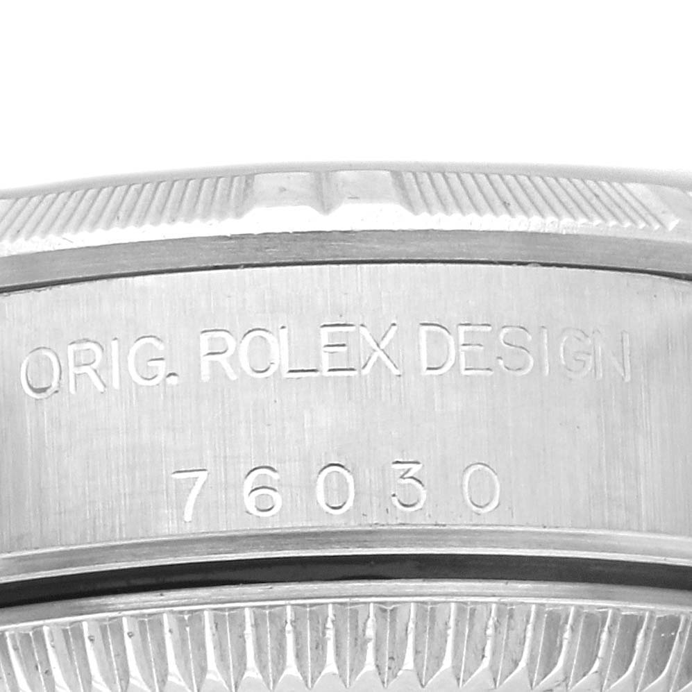 This image shows a close-up of the side of a Rolex Oyster Perpetual 76030 Women's Stainless Steel Pink Dial 76030 Women's Stainless Steel Pink Dial watch, highlighting the engraved model number 76030 and "ORIG. ROLEX DESIGN" text.