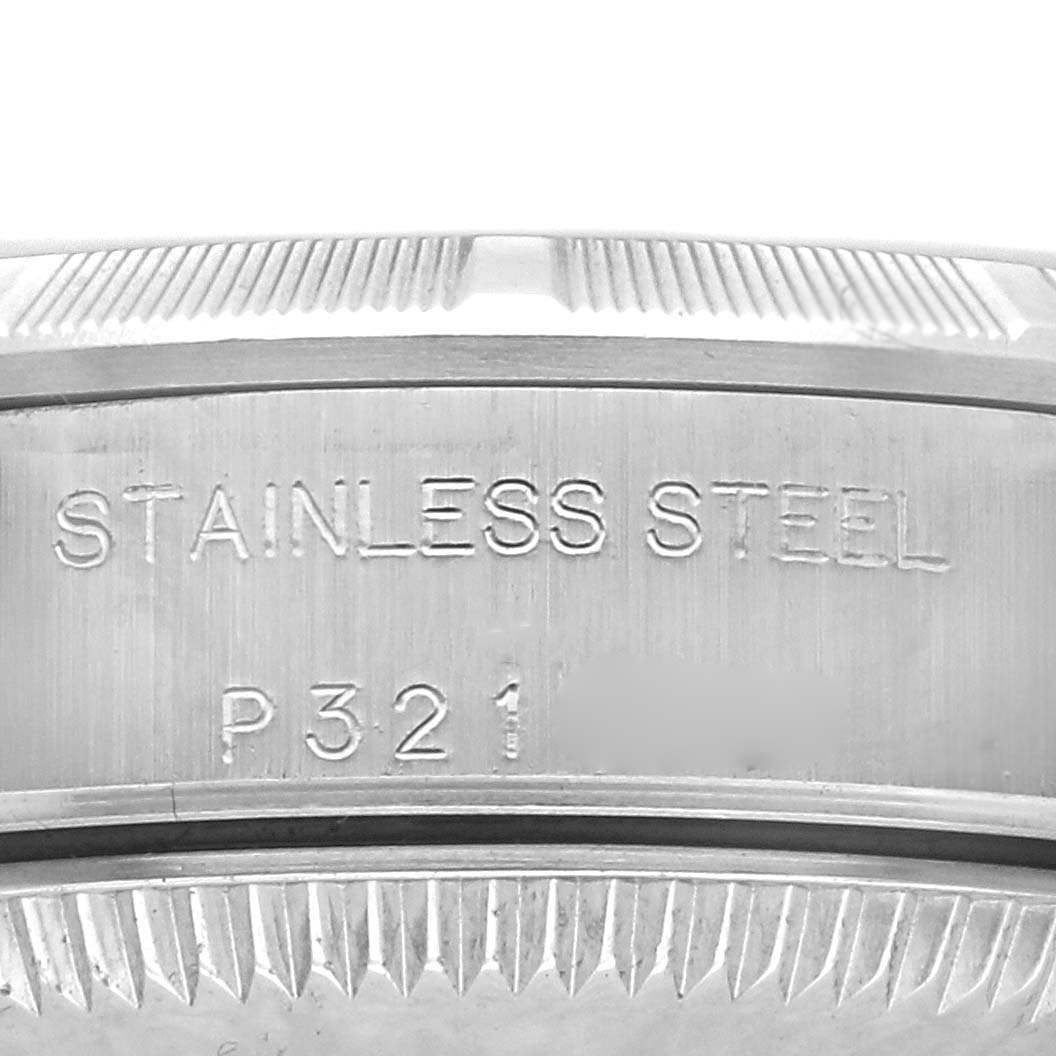This image shows a close-up of the side of the stainless steel case on a Rolex Oyster Perpetual 76030 Women's Stainless Steel Pink Dial 76030 Women's Stainless Steel Pink Dial watch, featuring engraved details.