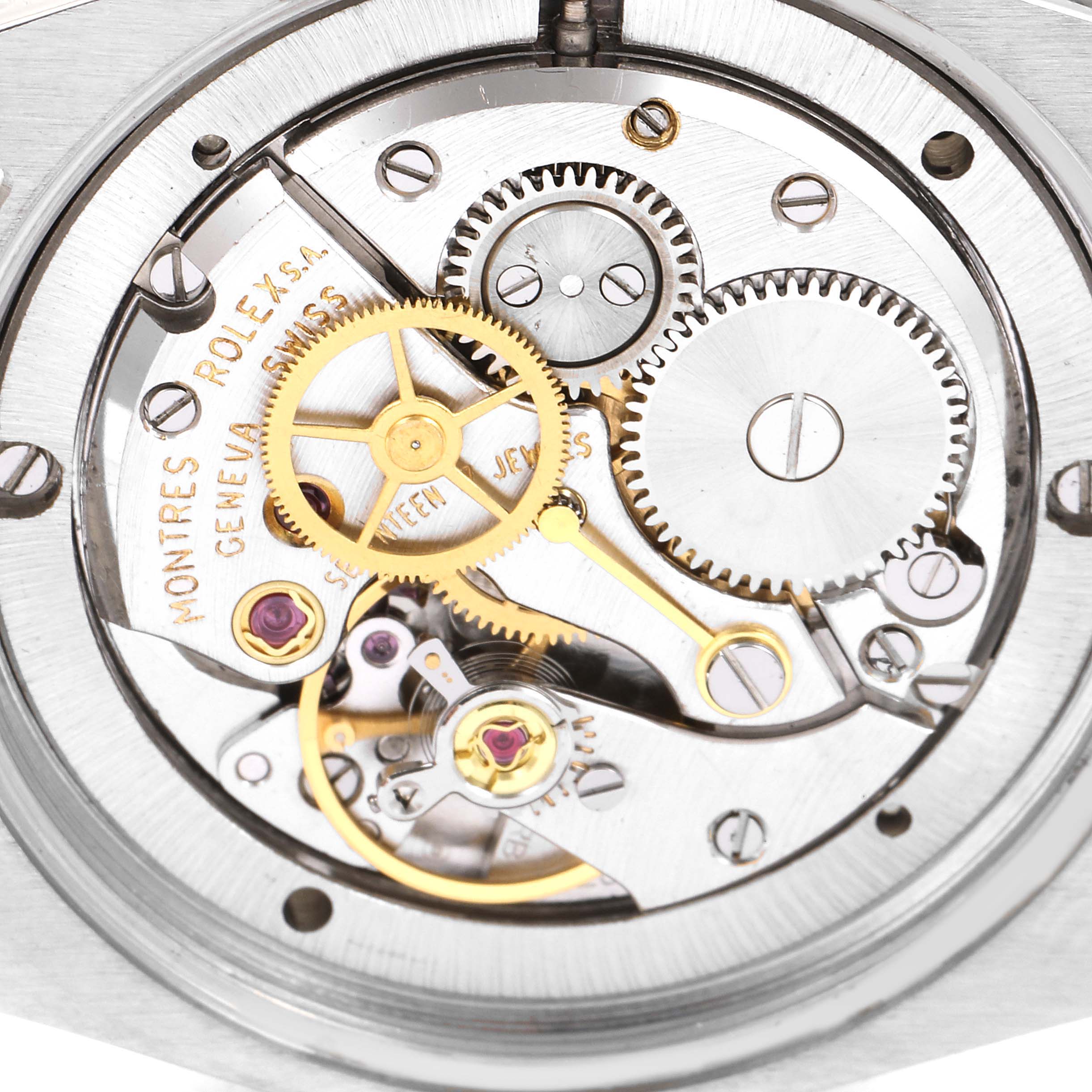 The image shows the internal mechanism of a Rolex Vintage Collection 6694 Men's Stainless Steel Black Dial 6694 Men's Stainless Steel Black Dial watch, highlighting gears and intricate components.